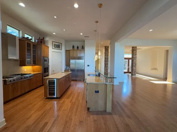 an empty room with wooden floor and outdoor view