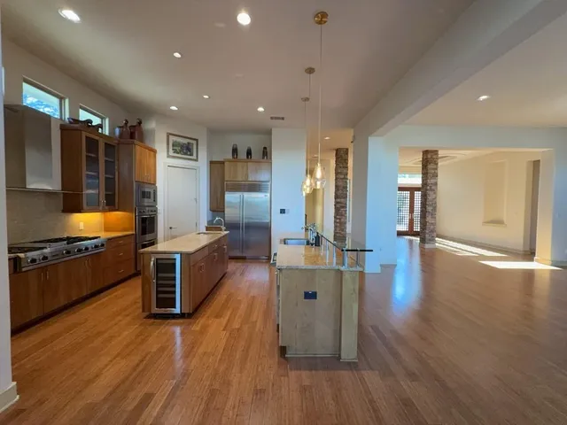 an empty room with wooden floor and outdoor view