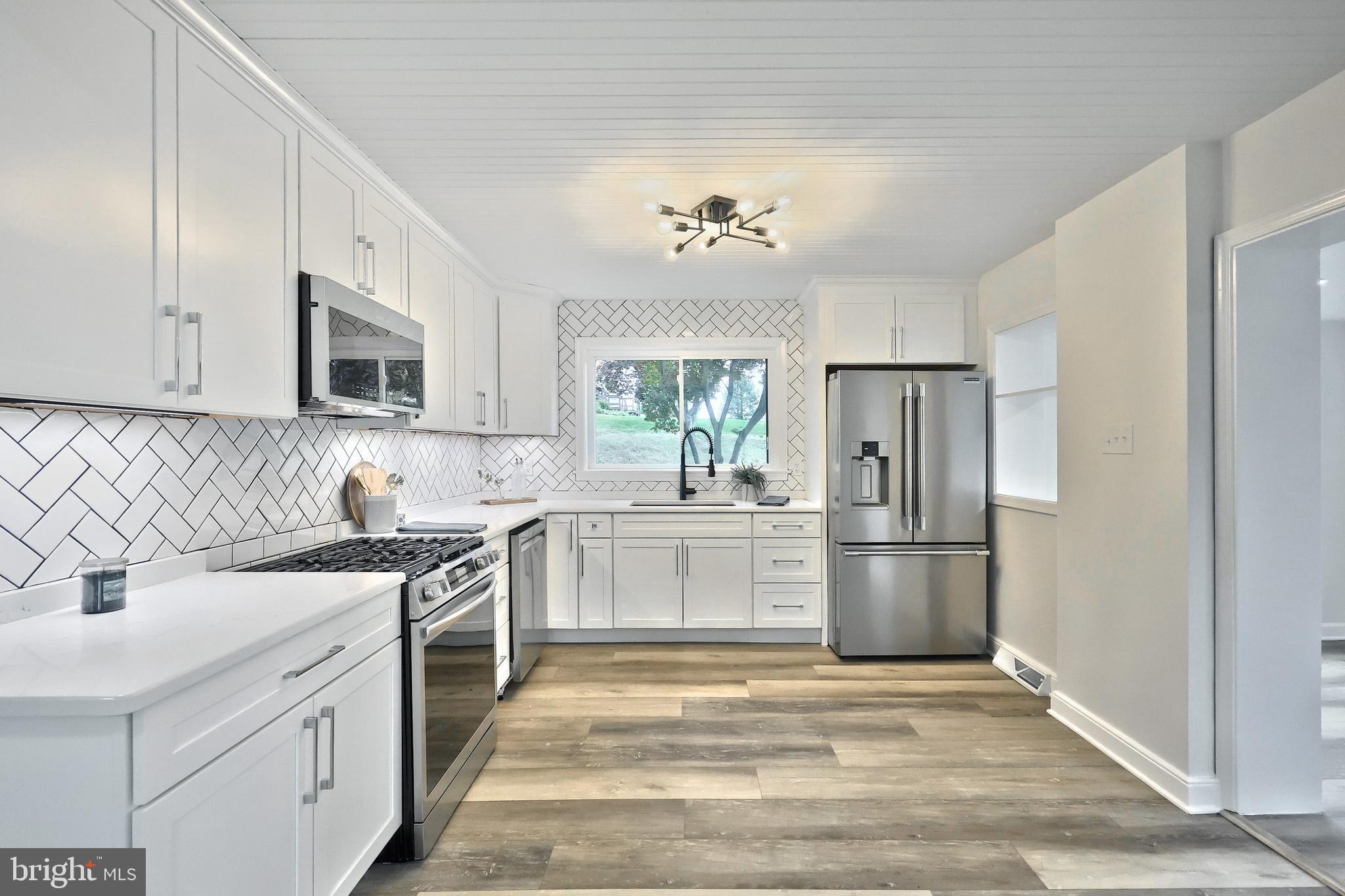3641 River Road Conestoga, PA 17516 - Photo 27 of 61 a kitchen with a sink stove and refrigerator