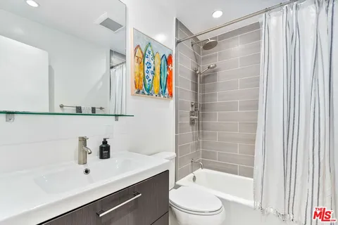 a bathroom with a sink mirror toilet and bathtub