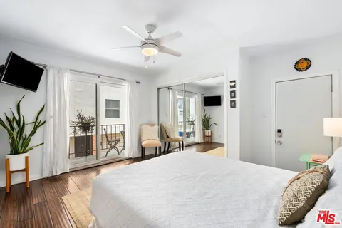 a bedroom with a large bed and a large window