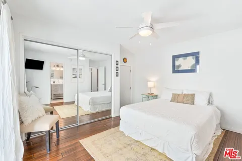 a bedroom with a white bed and white walls