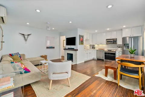 a living room with stainless steel appliances kitchen island granite countertop furniture and a kitchen view