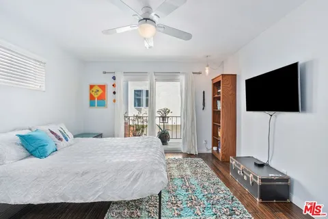 a bedroom with a bed and a flat screen tv