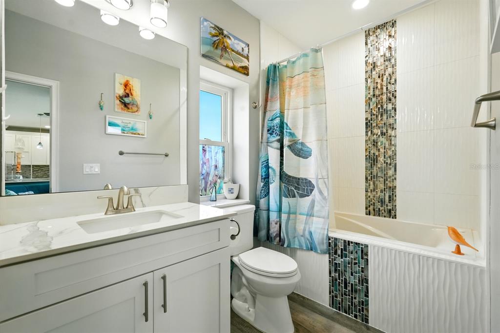3073 Painters Walk Flagler Beach, FL 32136 - Photo 13 of 66 a bathroom with a sink a toilet and shower