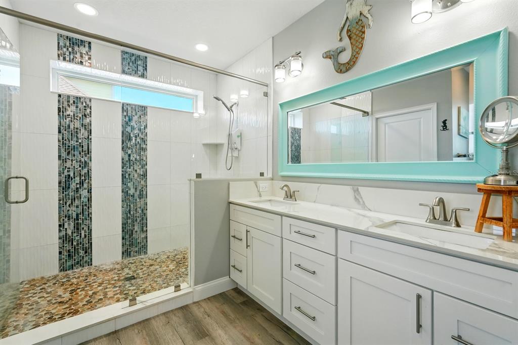 3073 Painters Walk Flagler Beach, FL 32136 - Photo 27 of 66 a bathroom with a sink mirror and a shower