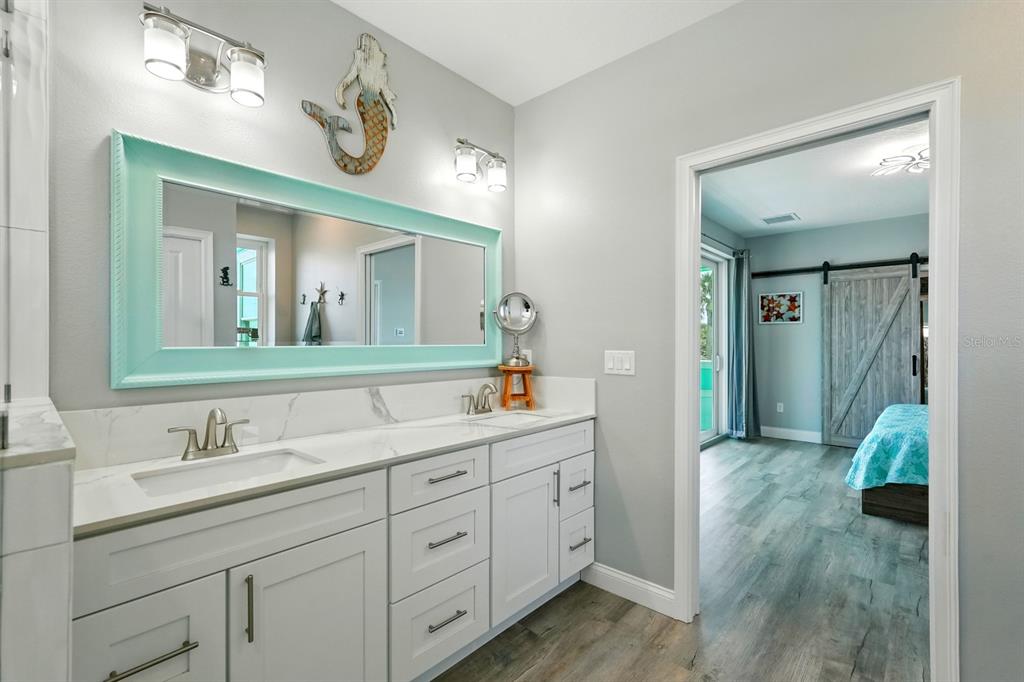 3073 Painters Walk Flagler Beach, FL 32136 - Photo 28 of 66 a spacious bathroom with a double vanity sink and a mirror