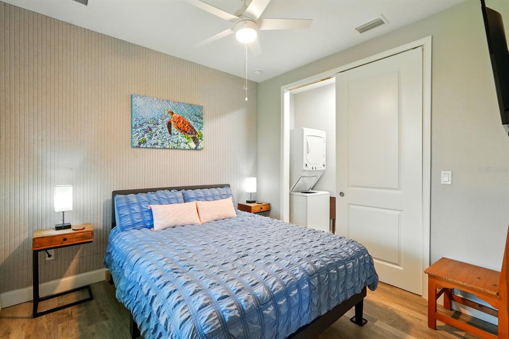 3073 Painters Walk Flagler Beach, FL 32136 - Photo 39 of 66 a bedroom with a bed and a chandelier