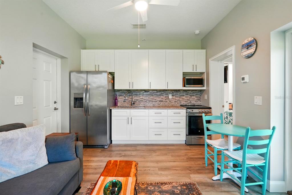 3073 Painters Walk Flagler Beach, FL 32136 - Photo 44 of 66 a kitchen with stainless steel appliances granite countertop a refrigerator and a stove top oven