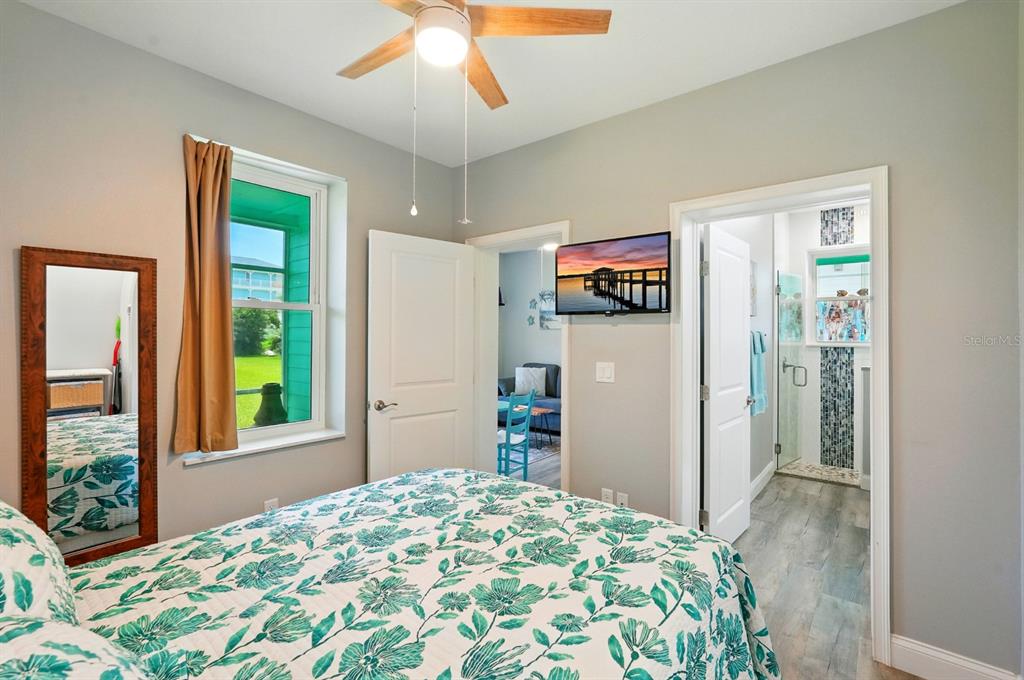 3073 Painters Walk Flagler Beach, FL 32136 - Photo 47 of 66 a bedroom with a bed and a chandelier