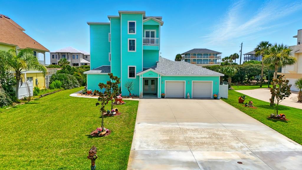 3073 Painters Walk Flagler Beach, FL 32136 - Photo 57 of 66 a front view of a house with a garden and yard