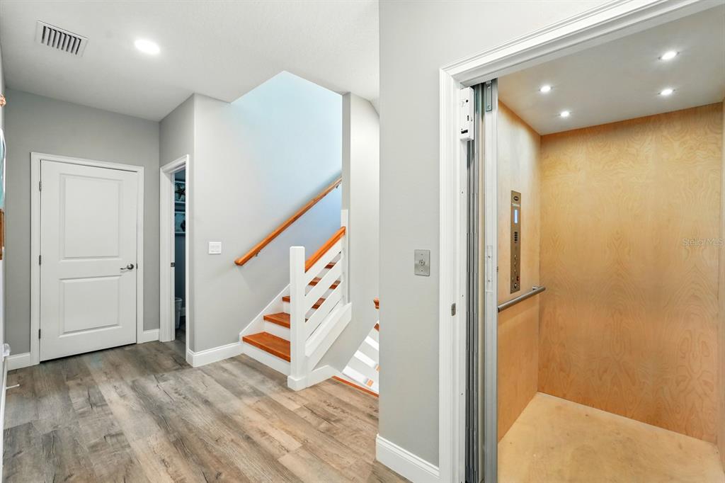 3073 Painters Walk Flagler Beach, FL 32136 - Photo 9 of 66 wooden floor with an entryway and chandelier in a room