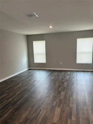 a view of room window and wooden floor