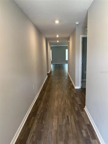 a view of hallway with wooden floor