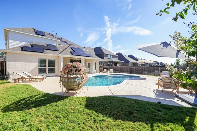 a view of a house with backyard porch and sitting area