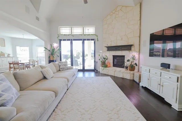 a living room with furniture a fireplace and a flat screen tv