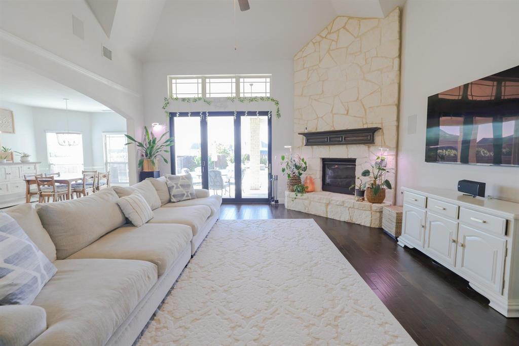 222 Crestview Drive Midlothian, TX 76065 - Photo 10 of 26 a living room with furniture a fireplace and a flat screen tv