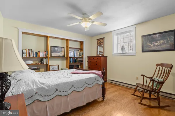 a bedroom with a bed a table and chair