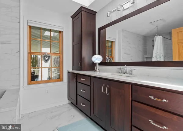 a bathroom with a double vanity sink and a mirror