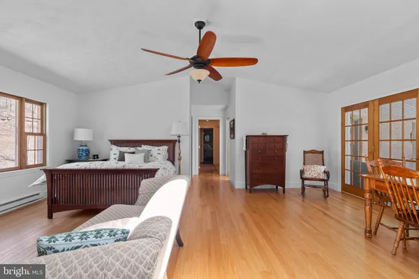 a bedroom with furniture and wooden floor