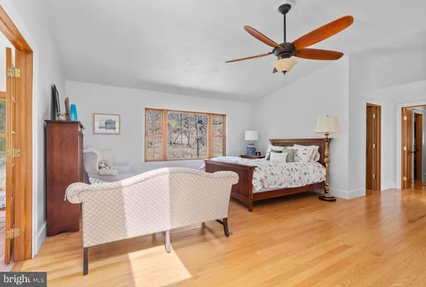 a bedroom with a bed and a chandelier