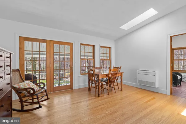 a dining room with furniture and wooden floor