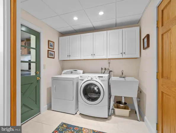 a utility room with sink dryer and washer