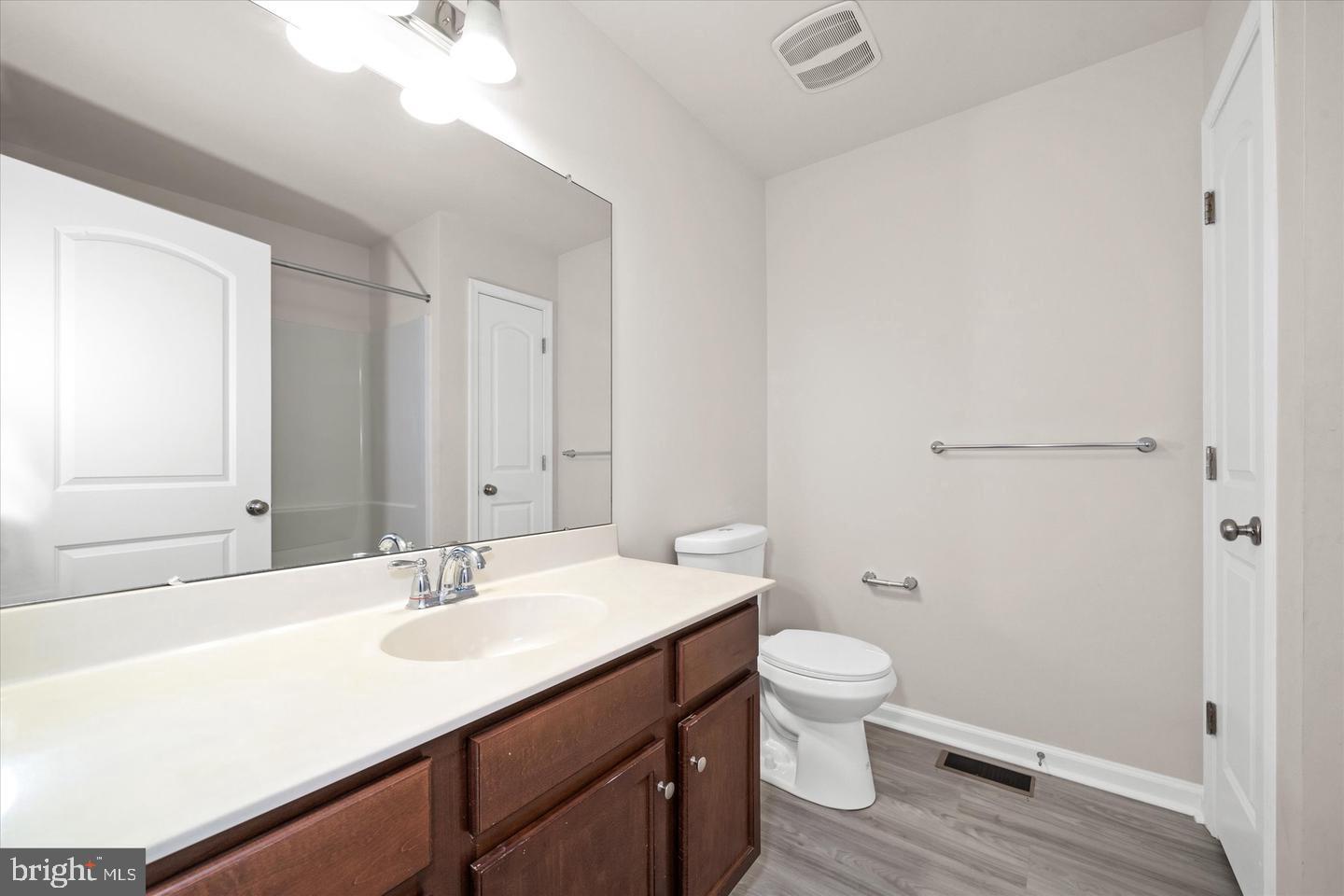 26 Munro Road Newark, DE 19711 - Photo 16 of 22 a bathroom with a sink a toilet a light fixture and a vanity
