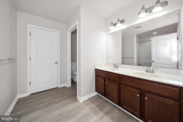 a bathroom with a double vanity sink and mirror