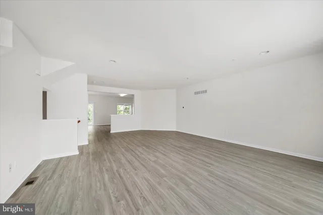 a view of an empty room and wooden floor