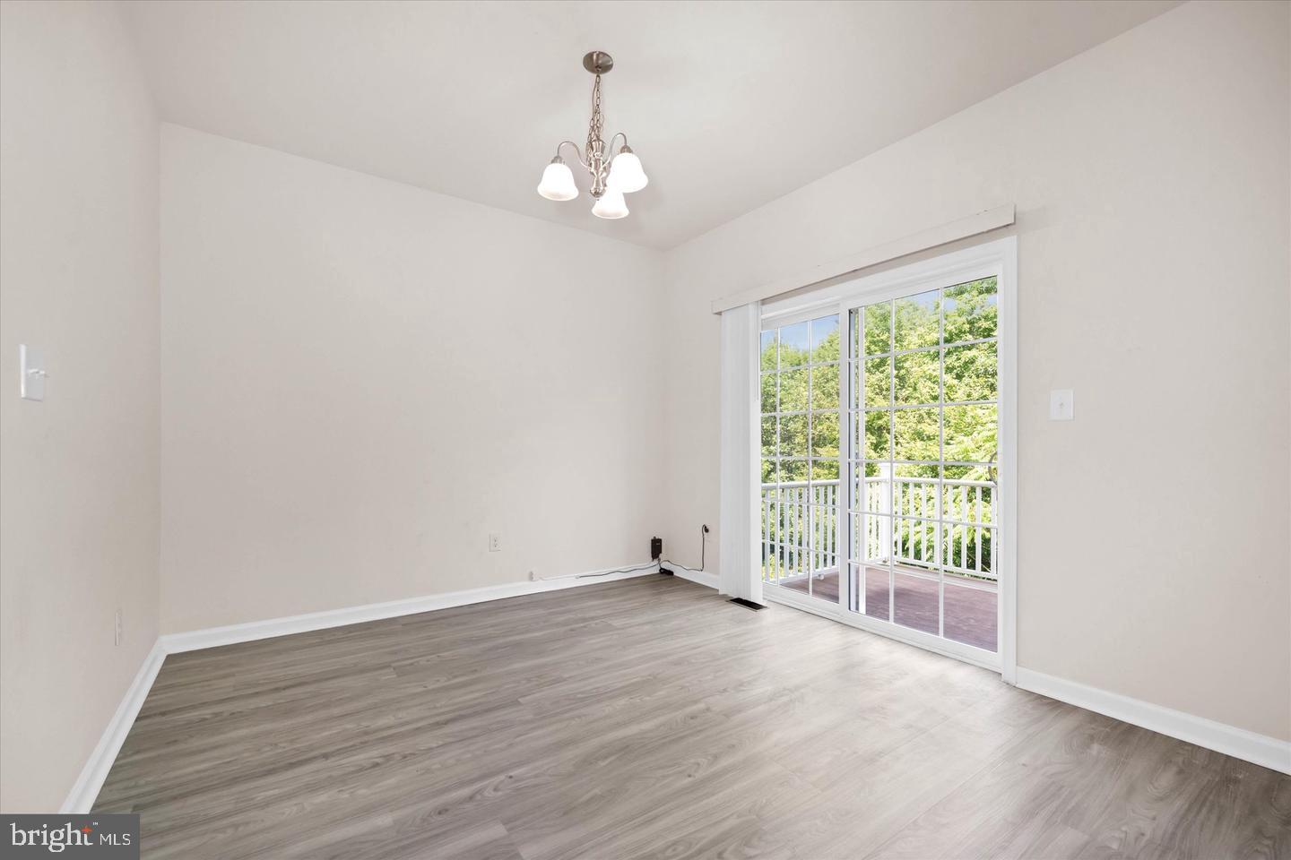 26 Munro Road Newark, DE 19711 - Photo 6 of 22 an empty room with wooden floor and windows