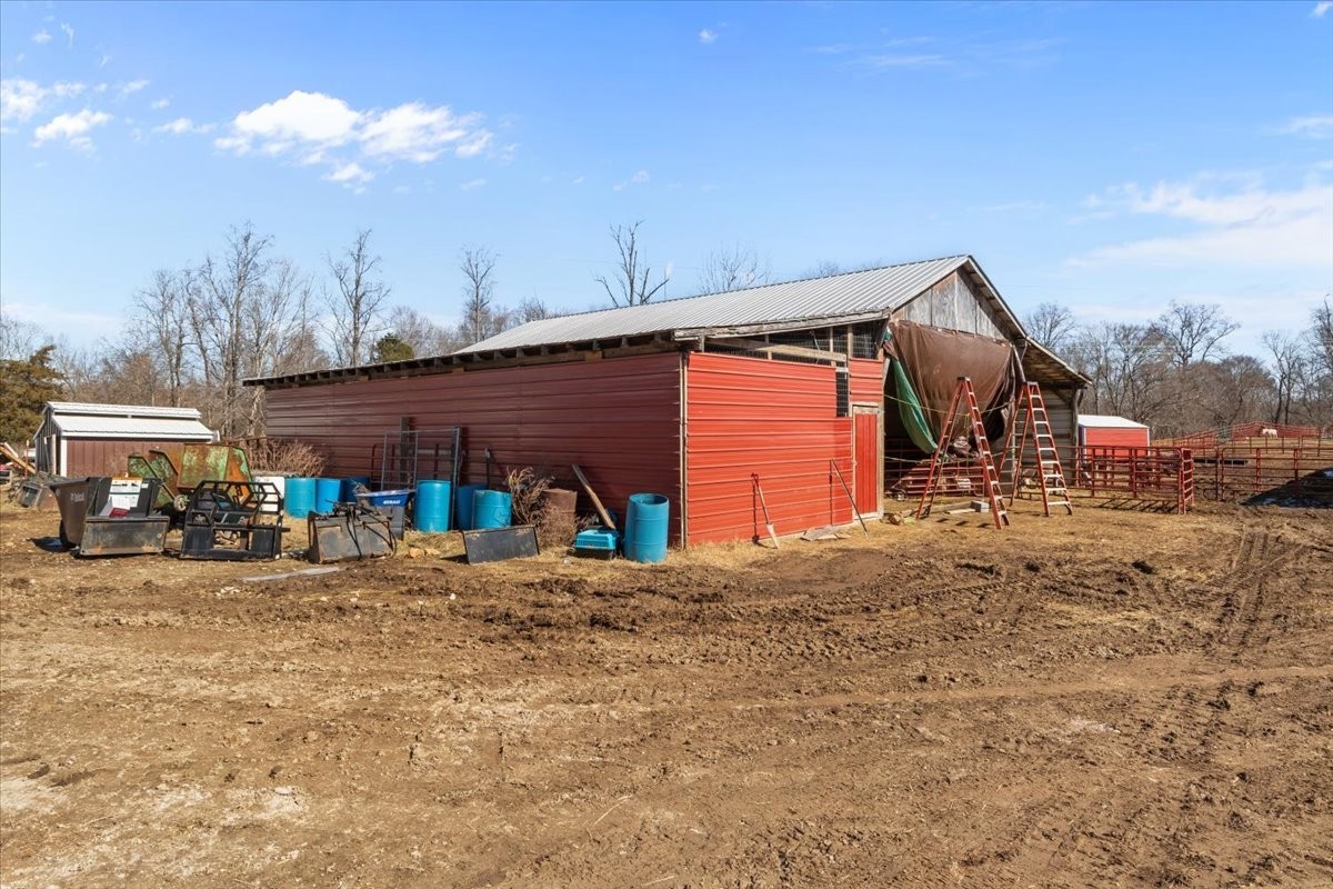 1429 Hunley Branch Road Charlotte, TN 37036 - Photo 23 of 51 a view of a house with large space and a car parked in it