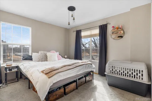 a bed sitting in a bedroom next to a window