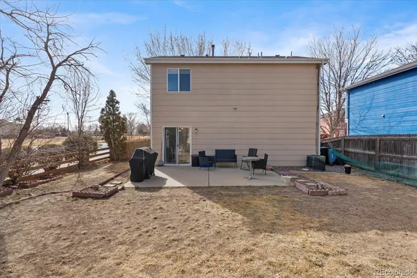 a view of a house with a yard and sitting area
