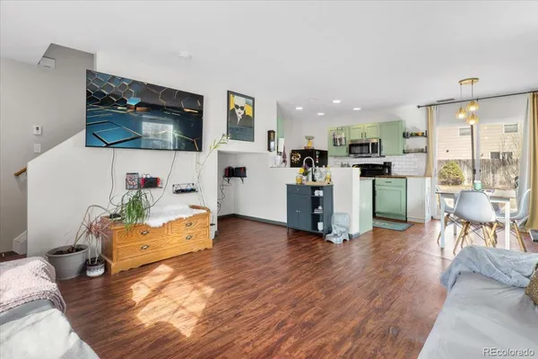 a living room with furniture and kitchen view