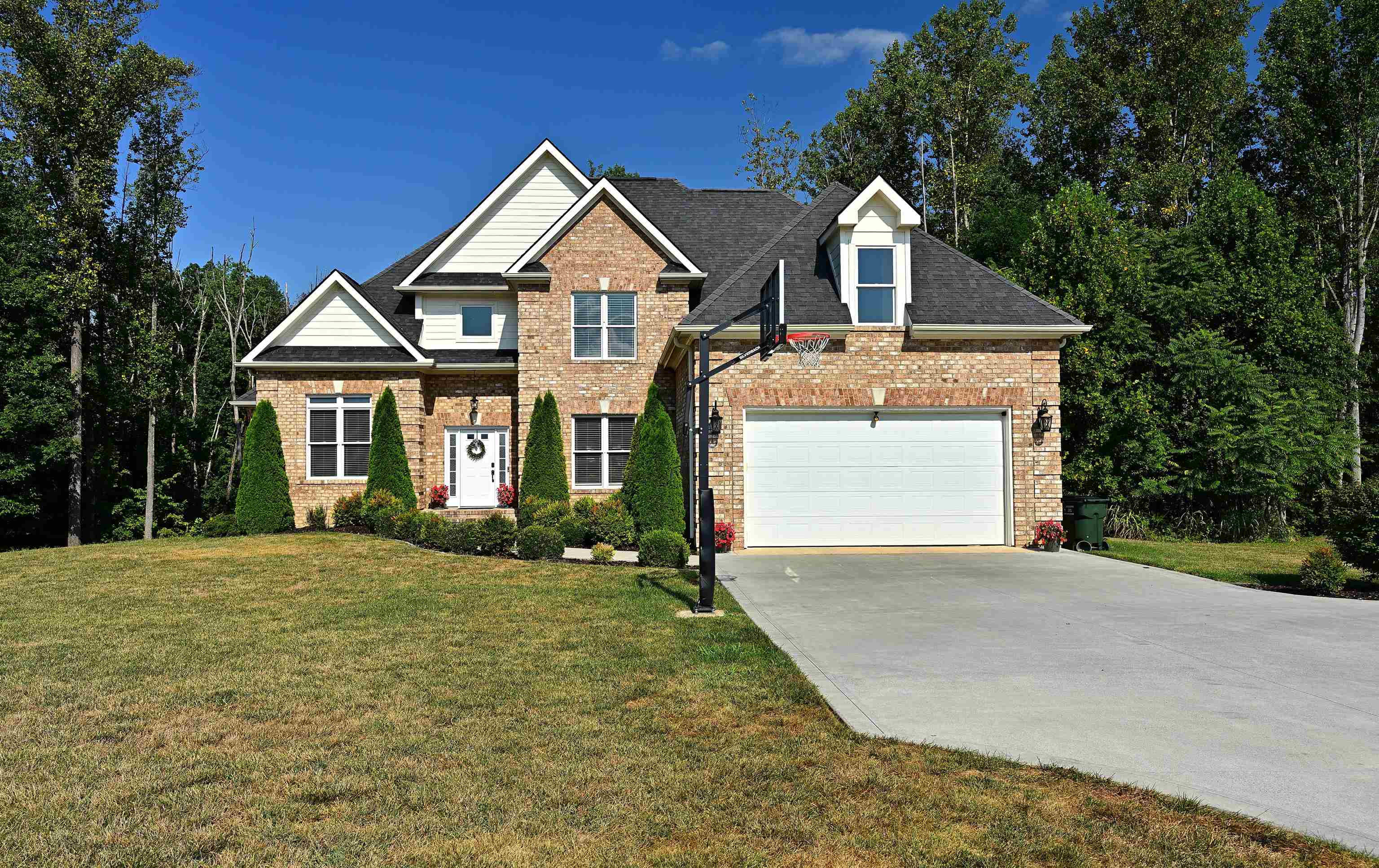 a front view of a house with a yard and garage