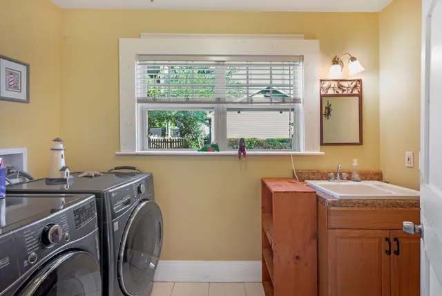 a utility room with a sink dryer and washer