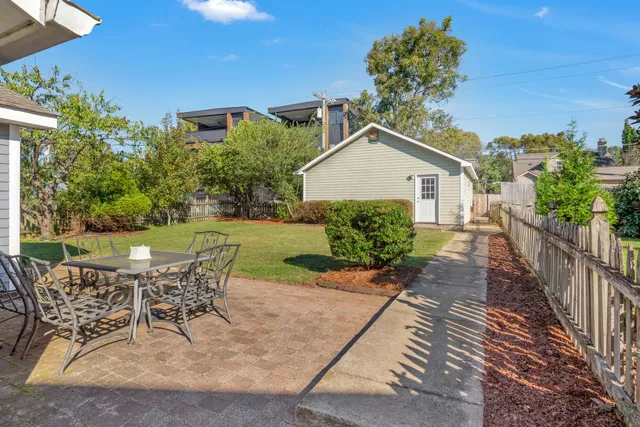 a view of a house with backyard and sitting area
