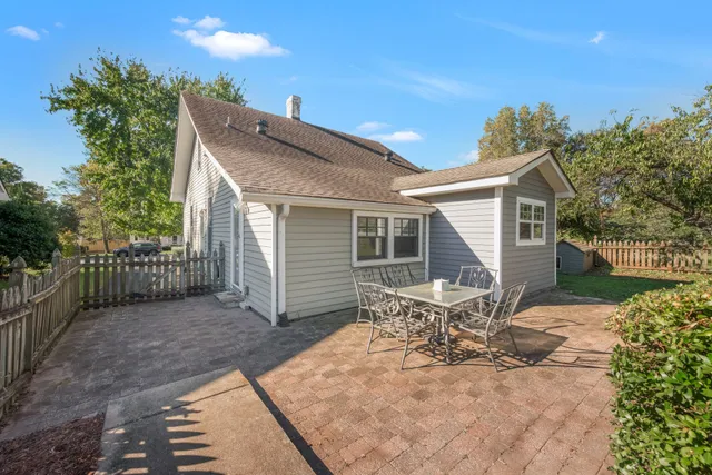 a view of a house with backyard and sitting area