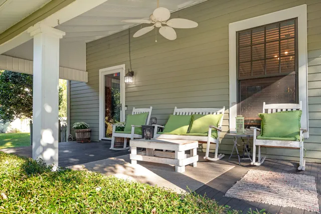 a view of a patio with chairs and potted plants