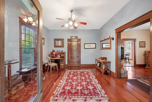 a living room with furniture and a wooden floor