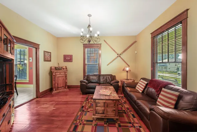 a living room with furniture and a chandelier