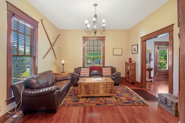 a living room with furniture and a chandelier