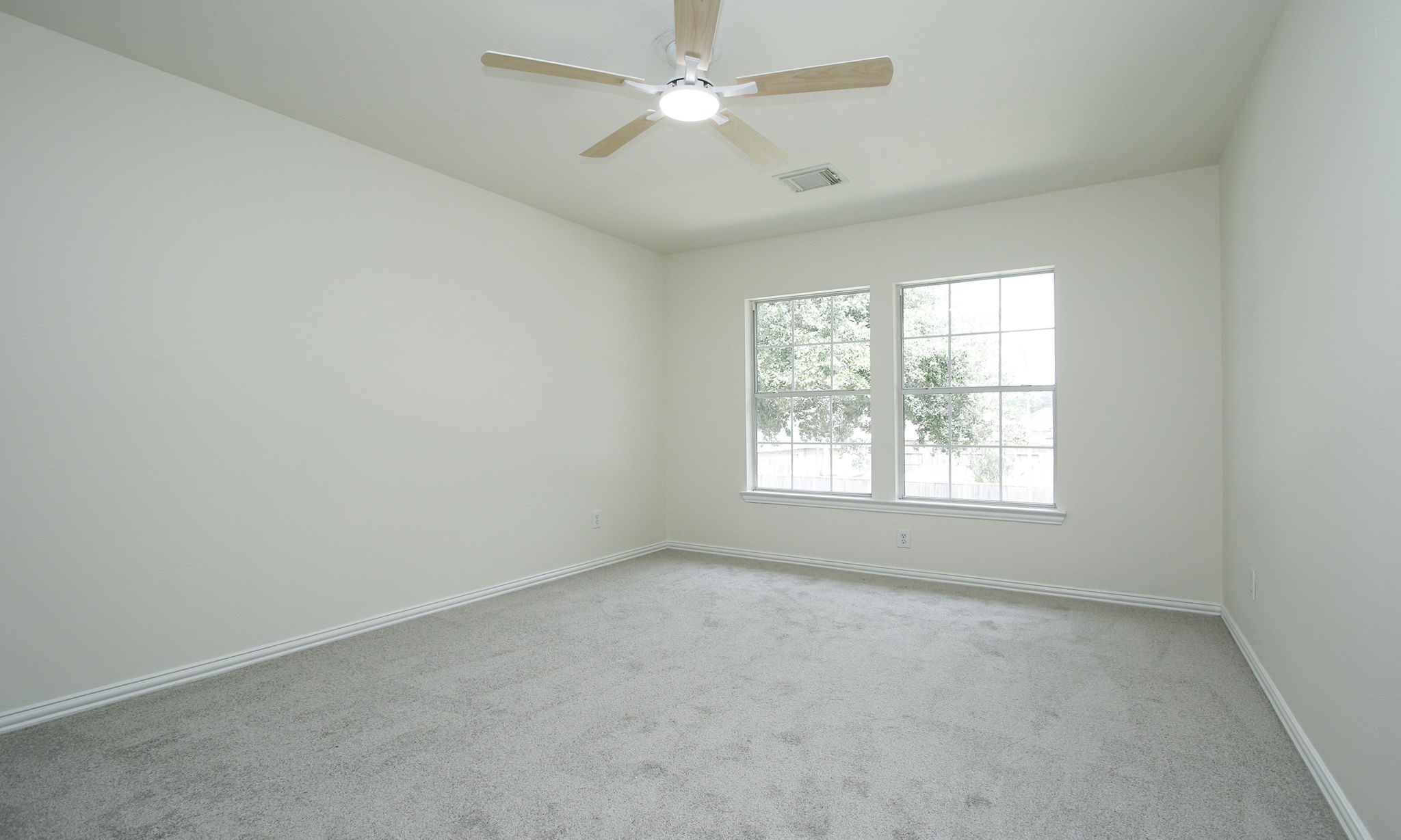 1210 Berwick Manor Court Spring, TX 77379 - Photo 39 of 50 an empty room with a window and a fan