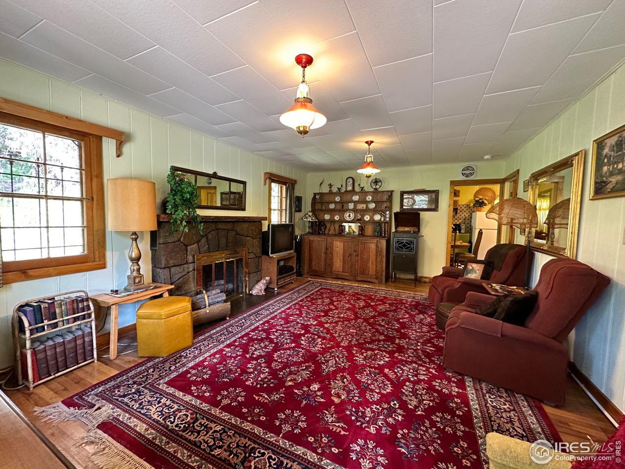 414 Riverside Drive Lyons, CO 80540 - Photo 12 of 23 a living room with furniture a flat screen tv and a fireplace