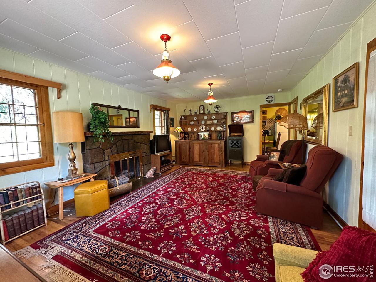 414 Riverside Drive Lyons, CO 80540 - Photo 14 of 23 a living room with furniture and a fireplace