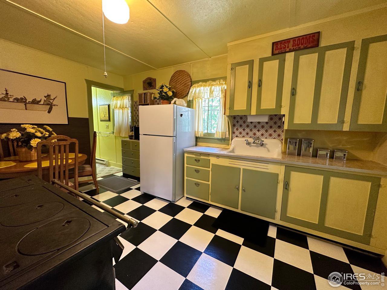 414 Riverside Drive Lyons, CO 80540 - Photo 19 of 23 a kitchen with a sink a refrigerator and cabinets