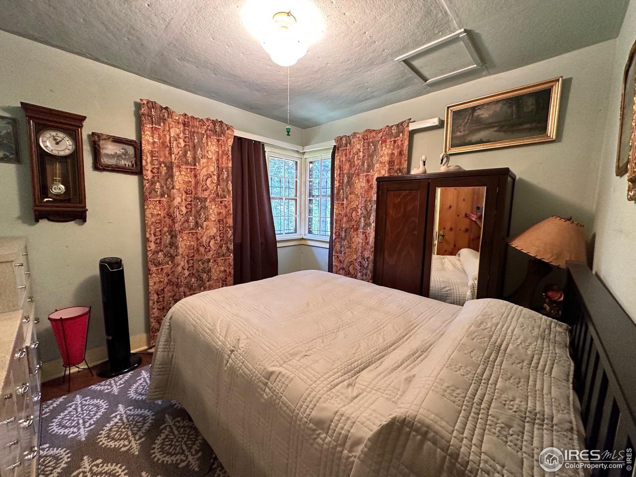 414 Riverside Drive Lyons, CO 80540 - Photo 20 of 23 a bedroom with a bed and a mirror