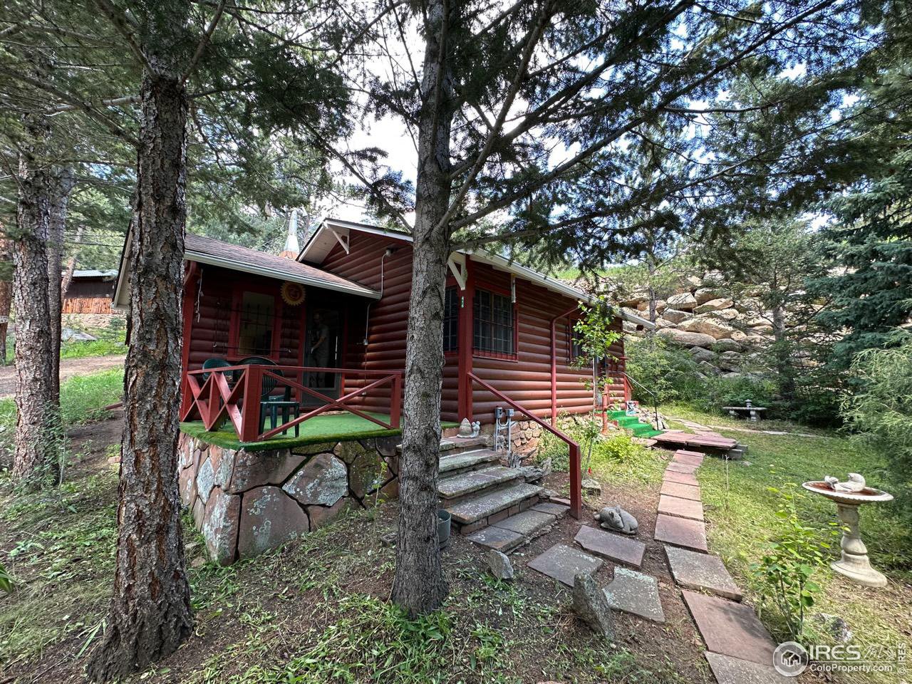 414 Riverside Drive Lyons, CO 80540 - Photo 2 of 23 a view of a back yard of the house and a bench