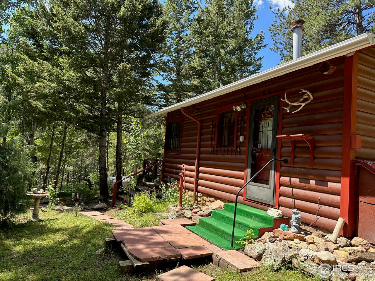 414 Riverside Drive Lyons, CO 80540 - Photo 3 of 23 a view of a backyard with table and chairs and potted plants